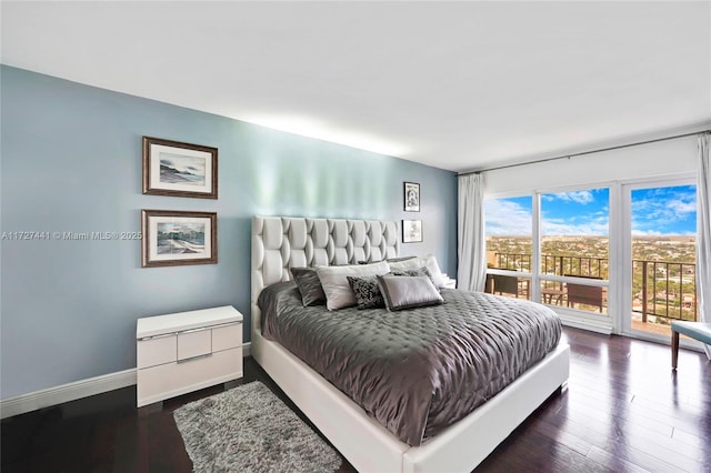 bedroom featuring access to exterior and dark hardwood / wood-style floors