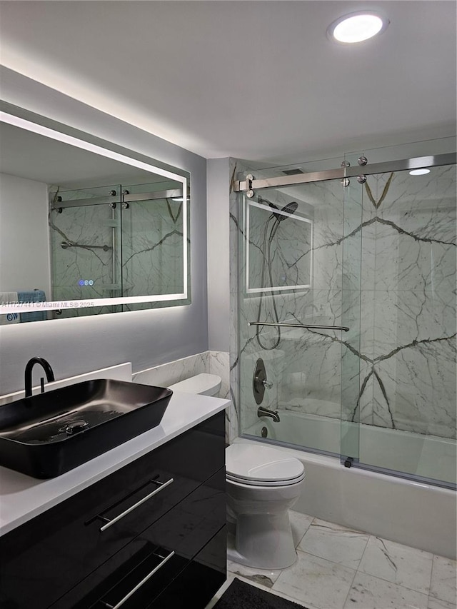 full bathroom with vanity, combined bath / shower with glass door, and toilet