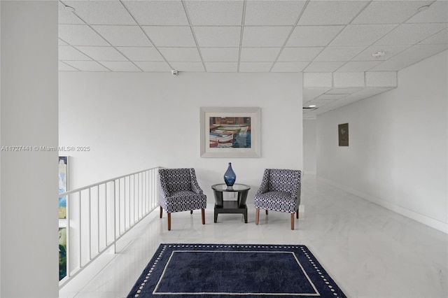 sitting room with a paneled ceiling