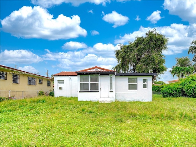 back of property featuring a lawn