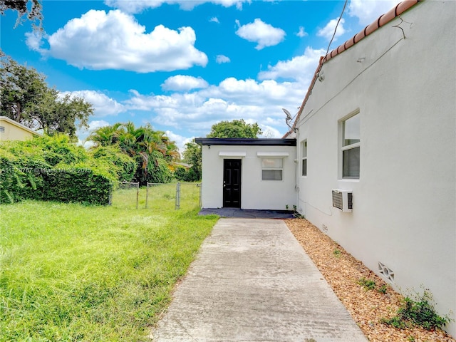 view of yard featuring a wall mounted air conditioner and a patio