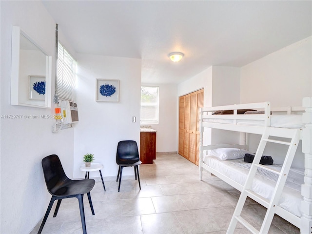 bedroom featuring a closet and light tile patterned floors