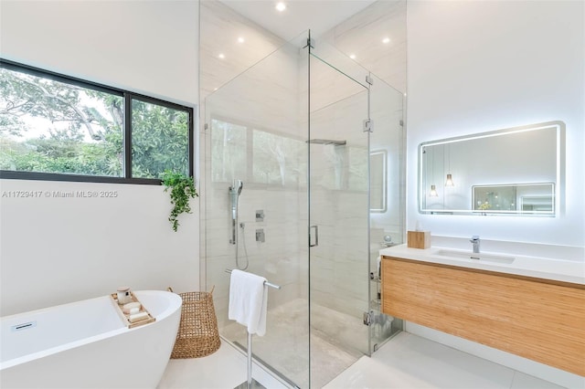 bathroom featuring tile patterned floors, vanity, and shower with separate bathtub