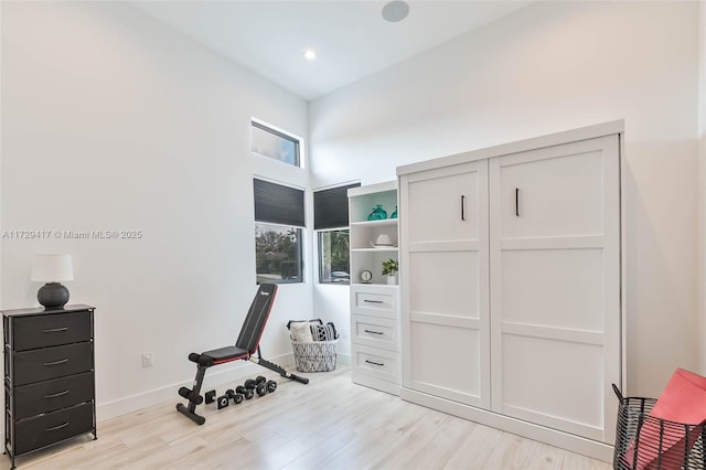 exercise room featuring light hardwood / wood-style floors