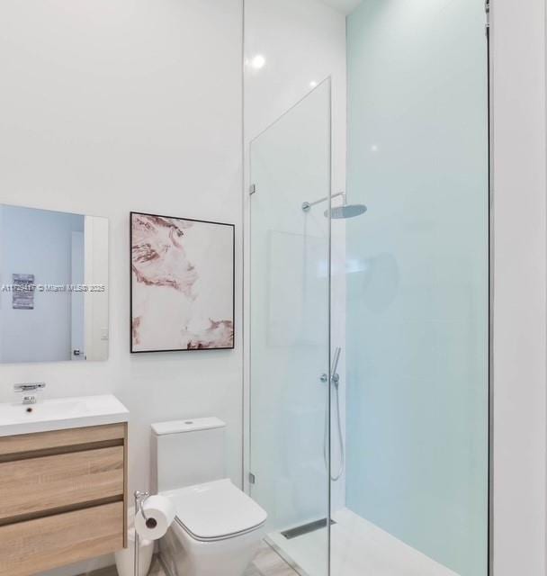 bathroom with vanity, toilet, and walk in shower