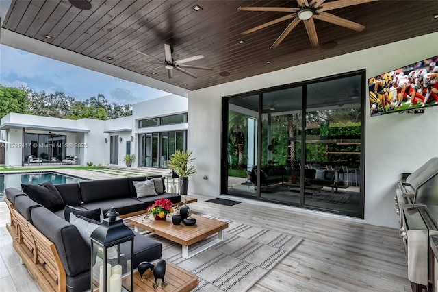 wooden deck with ceiling fan and an outdoor living space