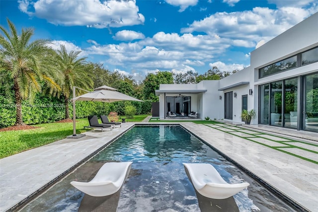 view of pool featuring ceiling fan and a patio area