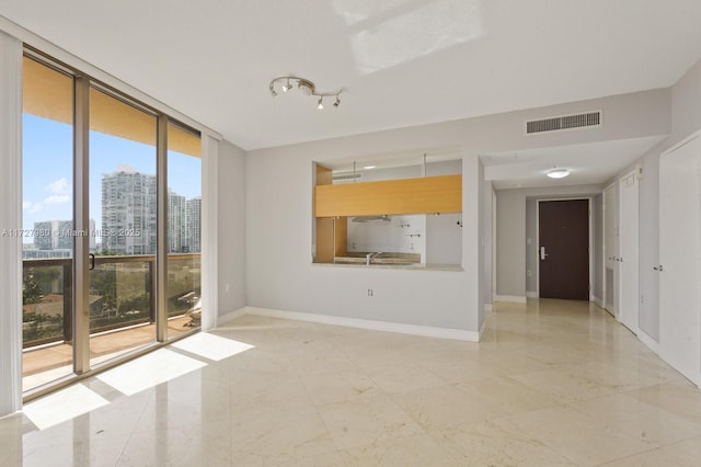 unfurnished living room with a wall of windows