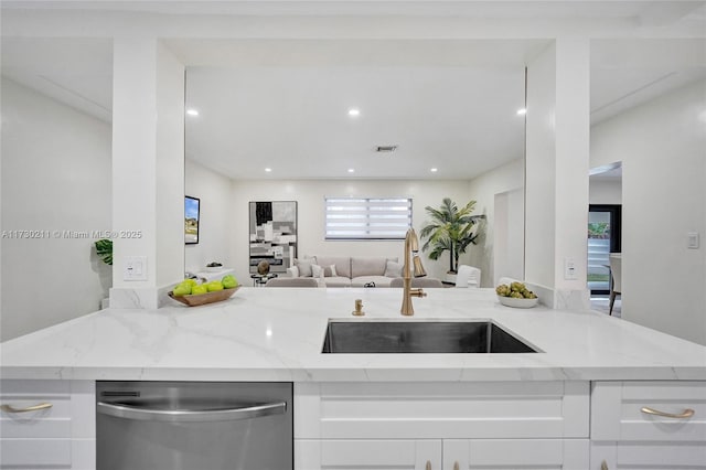 kitchen featuring white cabinets, light stone countertops, sink, and dishwasher