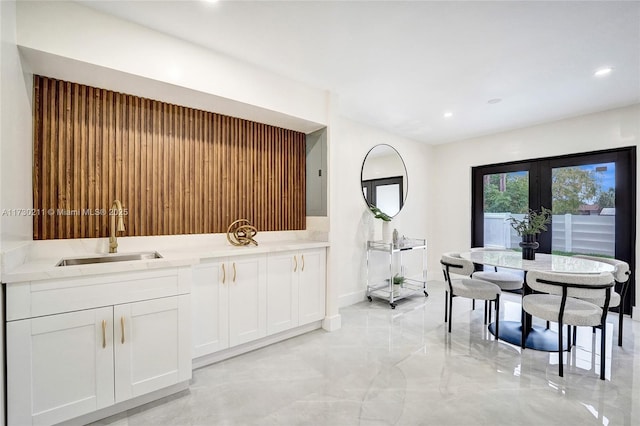 dining space with sink and french doors