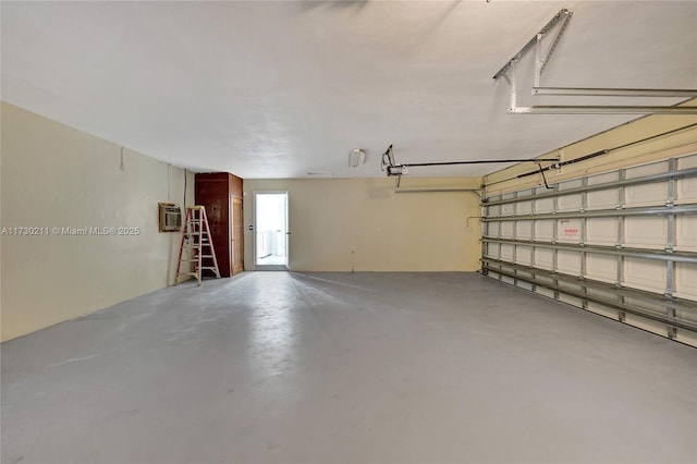 garage featuring a garage door opener and a wall mounted AC