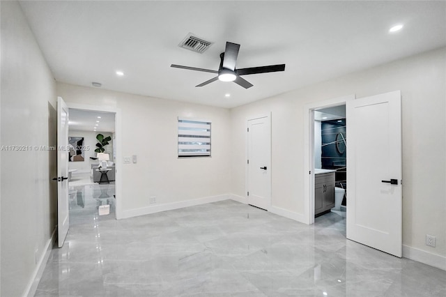 unfurnished bedroom featuring ceiling fan and ensuite bathroom