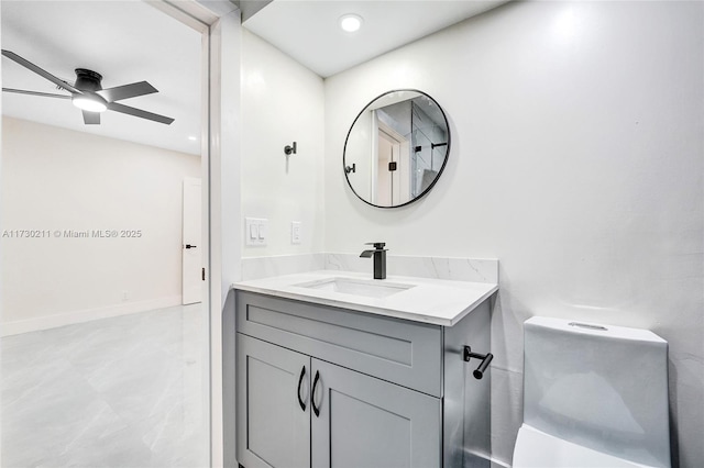 bathroom with vanity, ceiling fan, and toilet