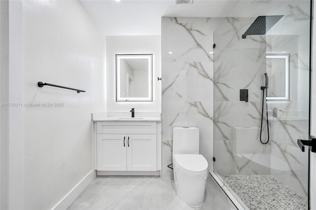 bathroom featuring vanity, toilet, and a tile shower