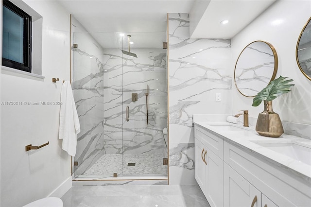 bathroom with a shower with door and vanity