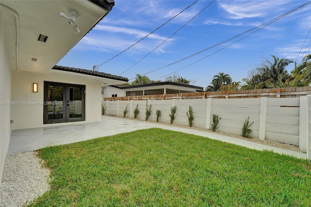 view of yard with a patio and french doors