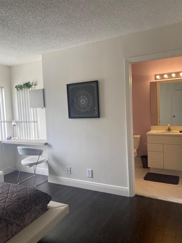 interior space with sink, hardwood / wood-style floors, and a textured ceiling