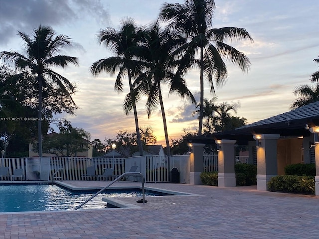 pool at dusk with a patio