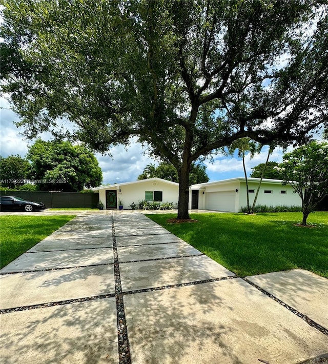 ranch-style house featuring a garage and a front yard