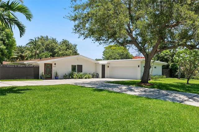 single story home with a garage and a front yard