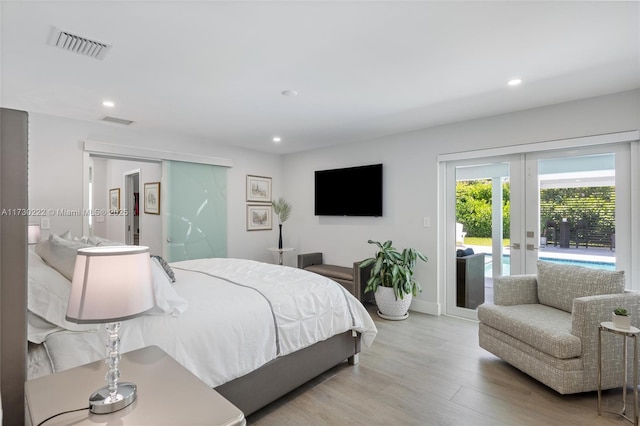 bedroom with access to outside, french doors, and light wood-type flooring