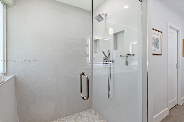 bathroom featuring a shower with door