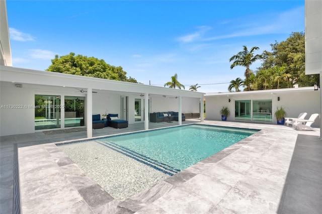 view of pool with ceiling fan, an outdoor living space, and a patio