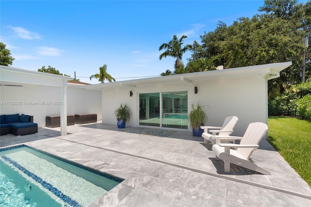 back of house featuring outdoor lounge area and a patio area