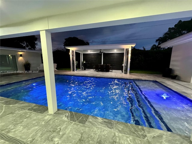 view of pool featuring ceiling fan and a patio