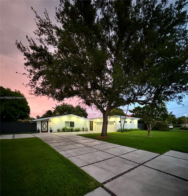 ranch-style home featuring a yard