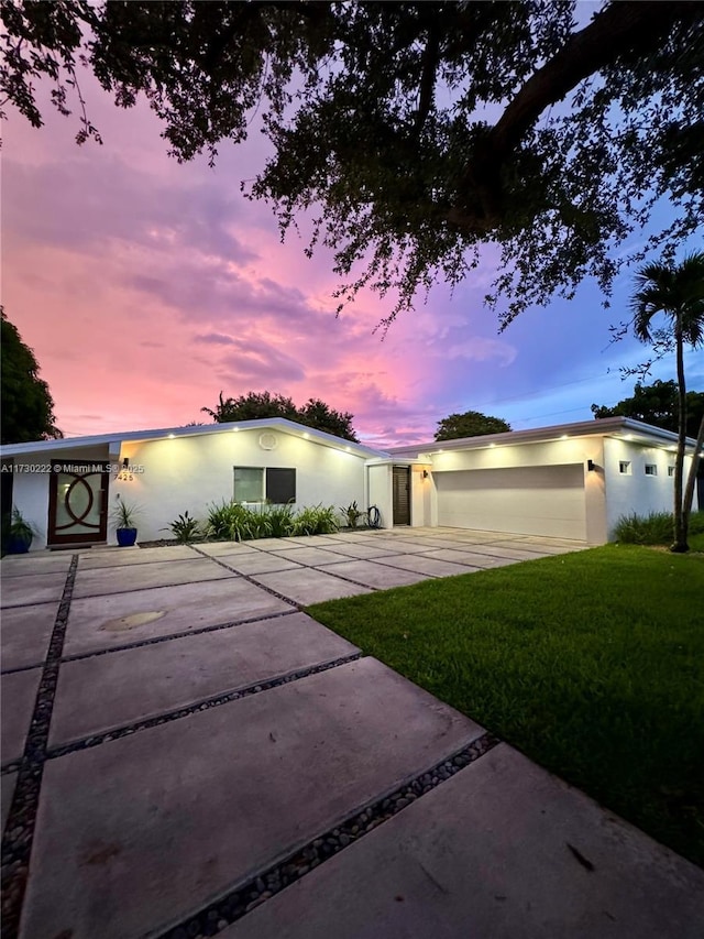 view of front facade with a garage and a lawn