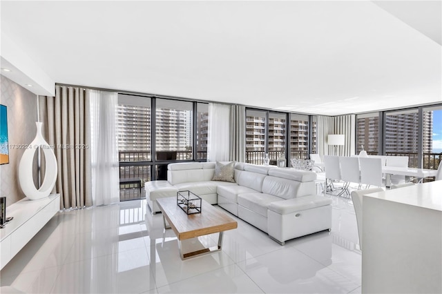 living room featuring floor to ceiling windows and light tile patterned floors