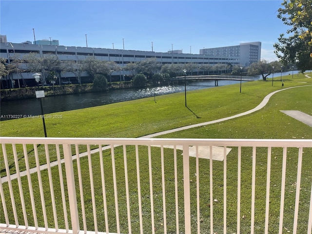 exterior space with a water view and a lawn