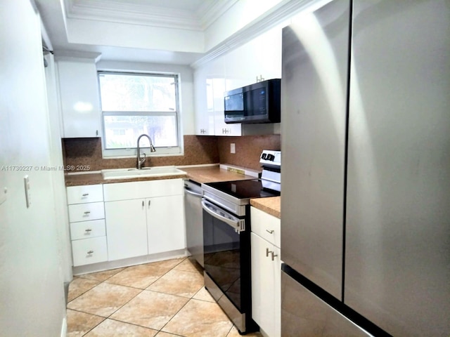 kitchen with a sink, tasteful backsplash, appliances with stainless steel finishes, and crown molding