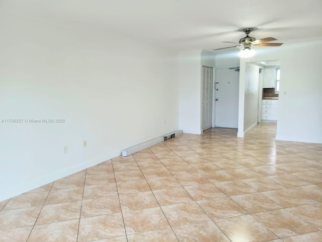 spare room with light tile patterned floors, baseboards, and a ceiling fan