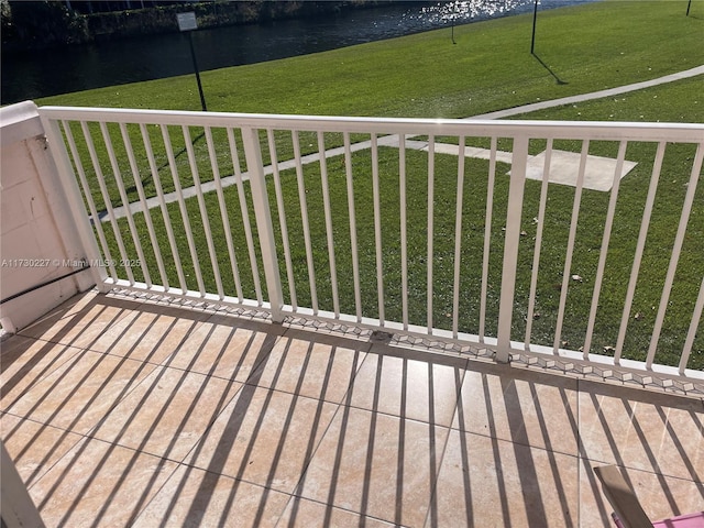 deck with a yard and a water view