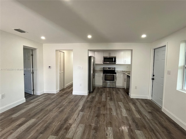 kitchen featuring white cabinetry, appliances with stainless steel finishes, and dark hardwood / wood-style floors