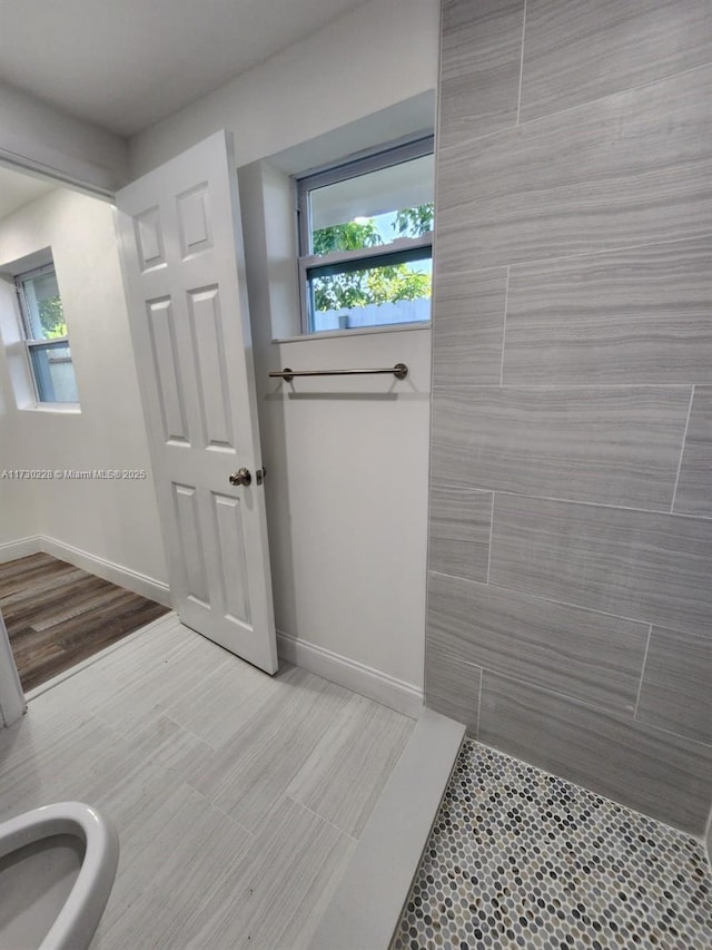 bathroom with walk in shower and tile patterned floors