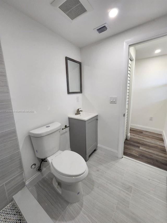 bathroom with vanity, toilet, and tile patterned flooring