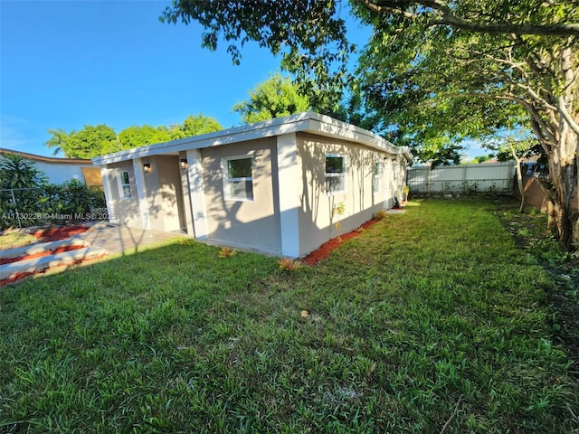 view of side of property with a lawn