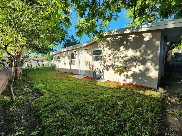 view of property exterior featuring a lawn