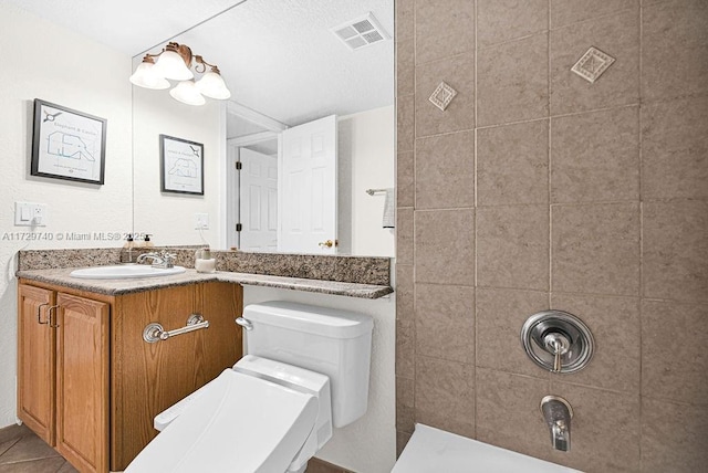 bathroom featuring tile patterned floors, vanity, and toilet