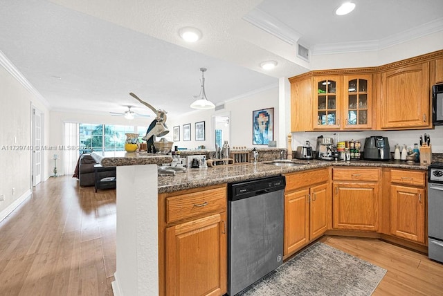 kitchen with crown molding, light hardwood / wood-style flooring, dark stone counters, and appliances with stainless steel finishes