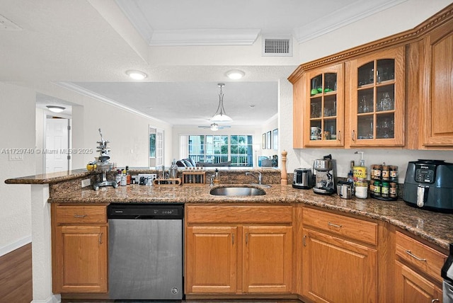 kitchen featuring sink, dark stone counters, ornamental molding, and stainless steel dishwasher