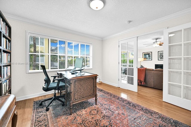 office featuring hardwood / wood-style flooring, french doors, and crown molding