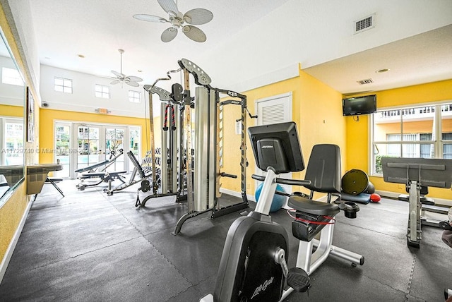 exercise room featuring a healthy amount of sunlight, ceiling fan, and french doors