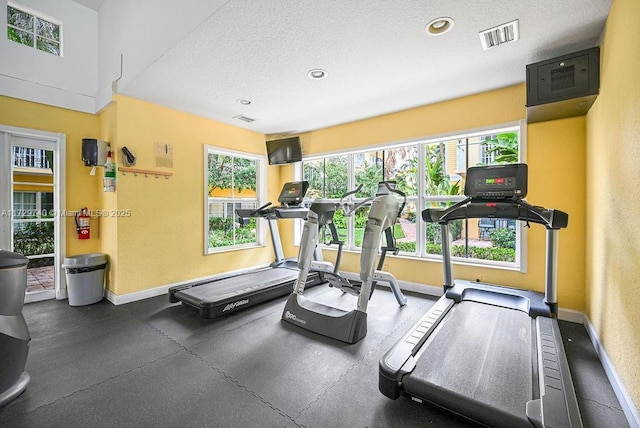 gym featuring a textured ceiling