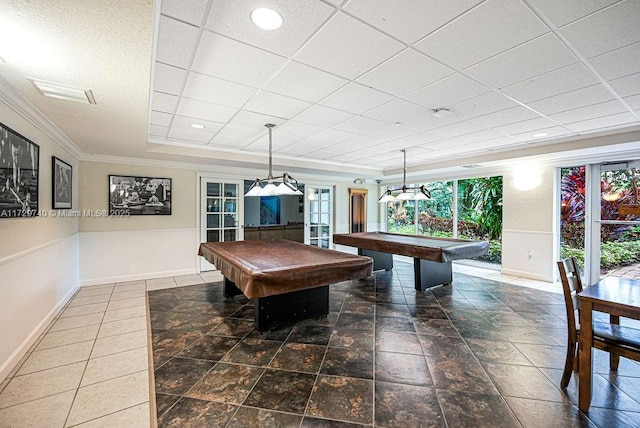 rec room featuring pool table, a tray ceiling, and ornamental molding