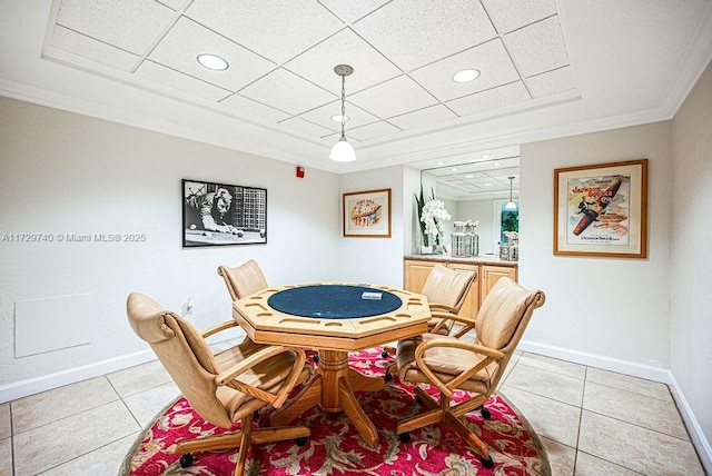 playroom with crown molding, a drop ceiling, and light tile patterned floors