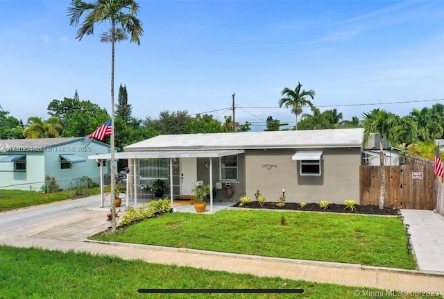 ranch-style home featuring a front yard